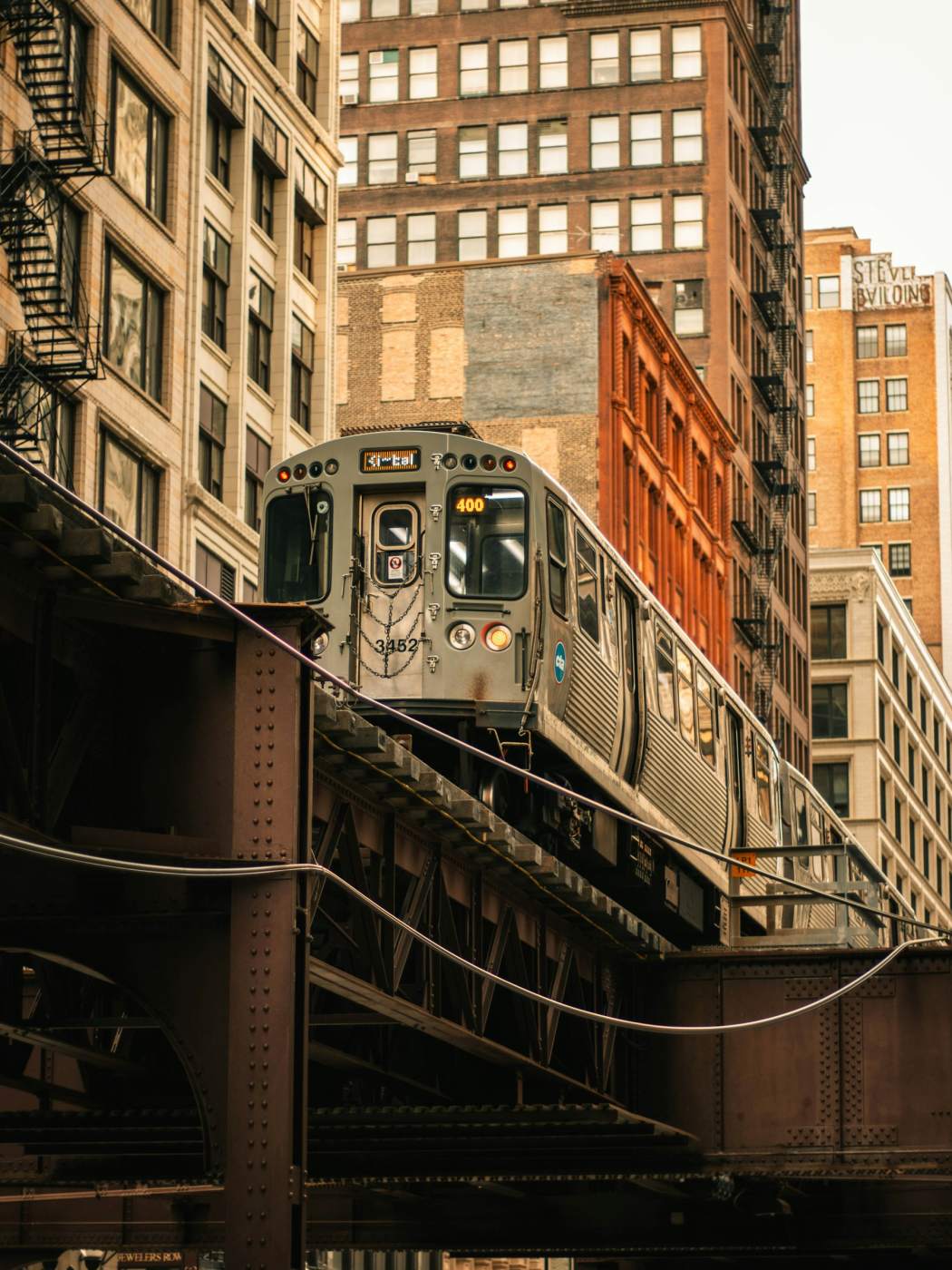 Chicago L train on the elevated Loop tracks between downtown buildings